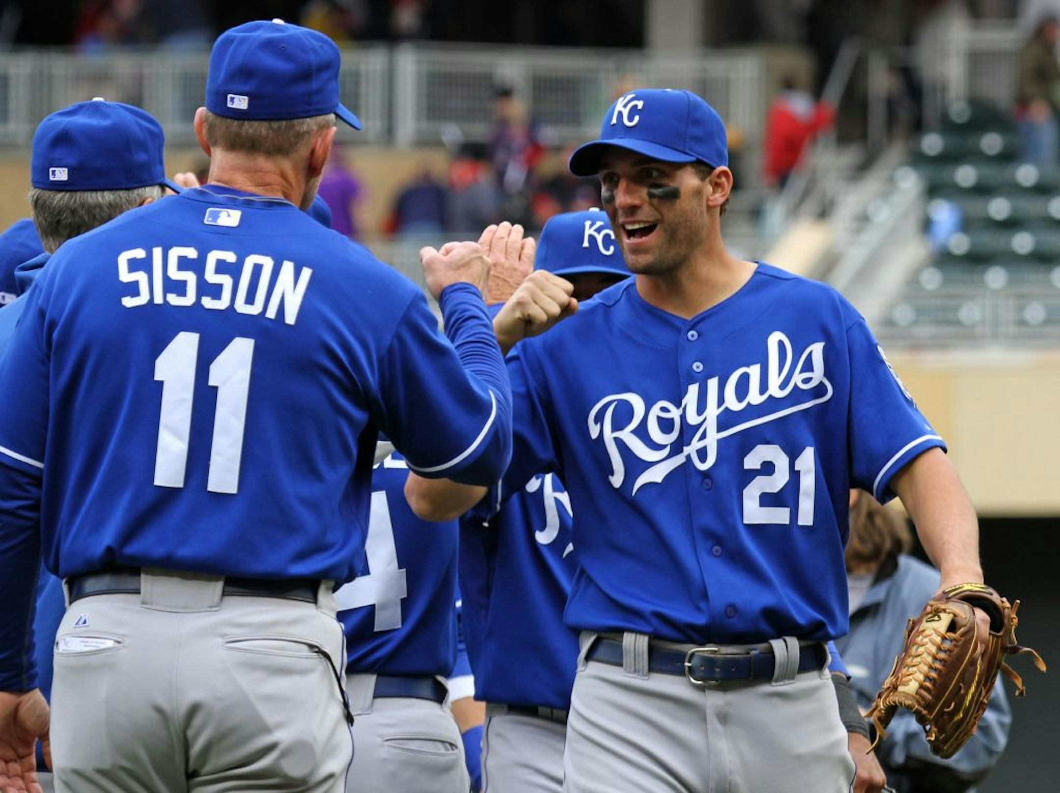 Royals first base coach Doug Sisson and Jeff Francoeur celebrated a win over the Twins.