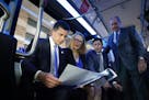 U.S. Transportation Secretary Pete Buttigieg studied the map of the proposed B Line as he took a tour. With him are Hennepin County Commissioners Mari