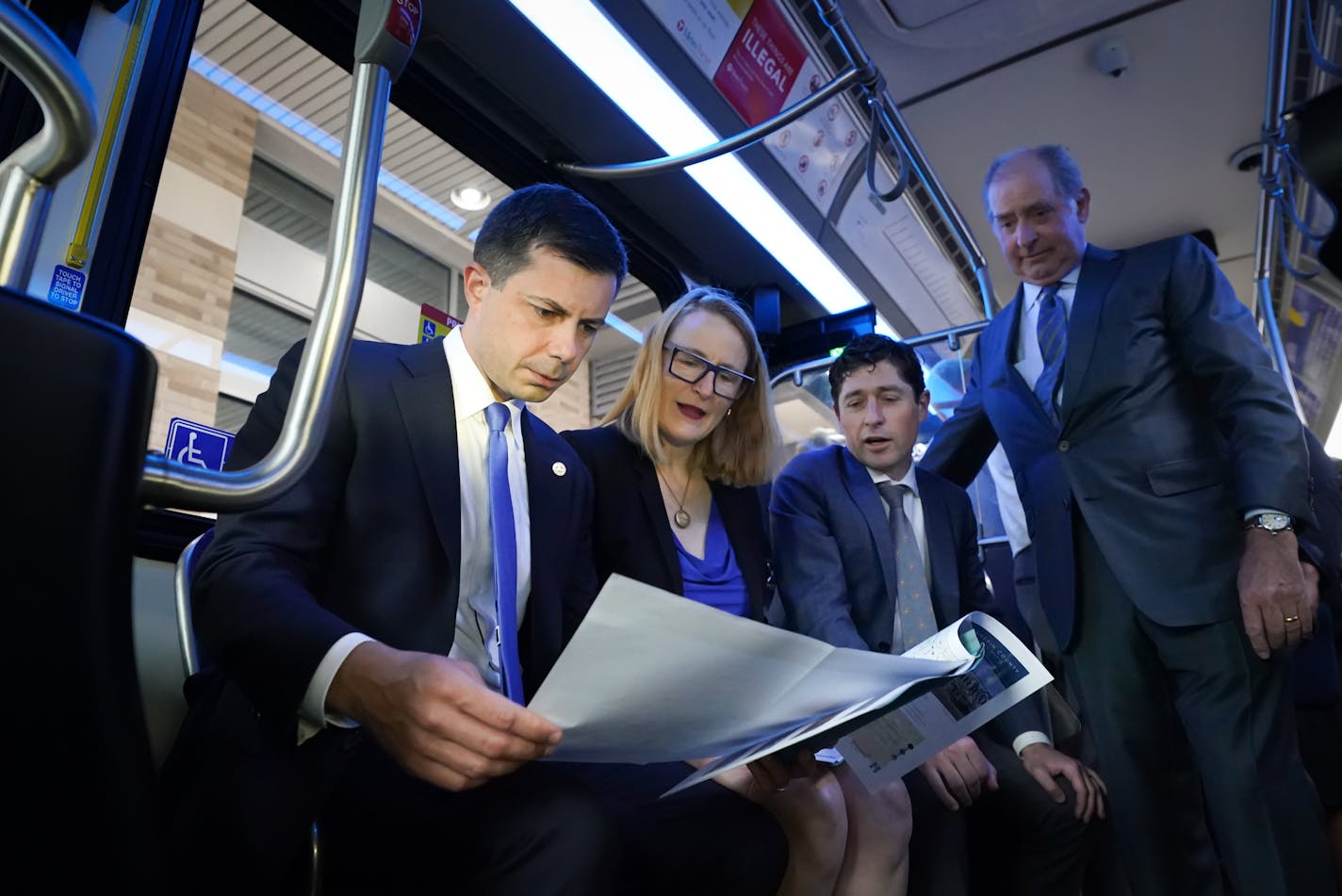 U.S. Transportation Secretary Pete Buttigieg studied the map of the proposed B Line as he took a tour. With him are Hennepin County Commissioners Marion Greene, Mayor Jacob Frey, and Met Council Chair Charles Zelle Thursday, Aug. 25, 2022, Minneapolis, Minn. U.S. Transportation Secretary Pete Buttigieg, on a four-day tour of six states to highlight infrastructure projects funded with federal dollars in the Biden administration's infrastructure act, will stop in Minneapolis to talk about a $12 million grant to support Bus Rapid Transit on the Lake Street Corridor with new turn lanes, bus only lanes, and ADA upgrades. ] GLEN STUBBE • glen.stubbe@startribune.com