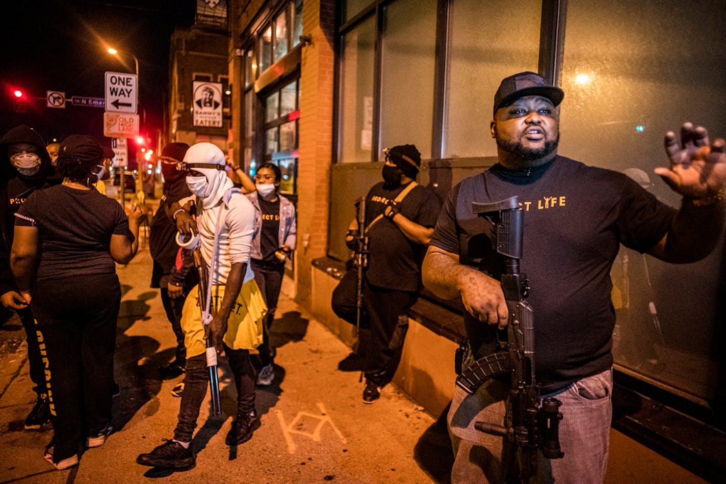 Tyrone Hartwell, a former Marine from Natchez, Miss., got ready to patrol around W. Broadway in north Minneapolis on Tuesday night. "I am not a threat," he said. "I am part of the solution."