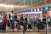 Travelers at Minneapolis-St. Paul International Airport in summer 2022.