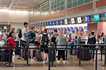 Travelers at Minneapolis-St. Paul International Airport in summer 2022.