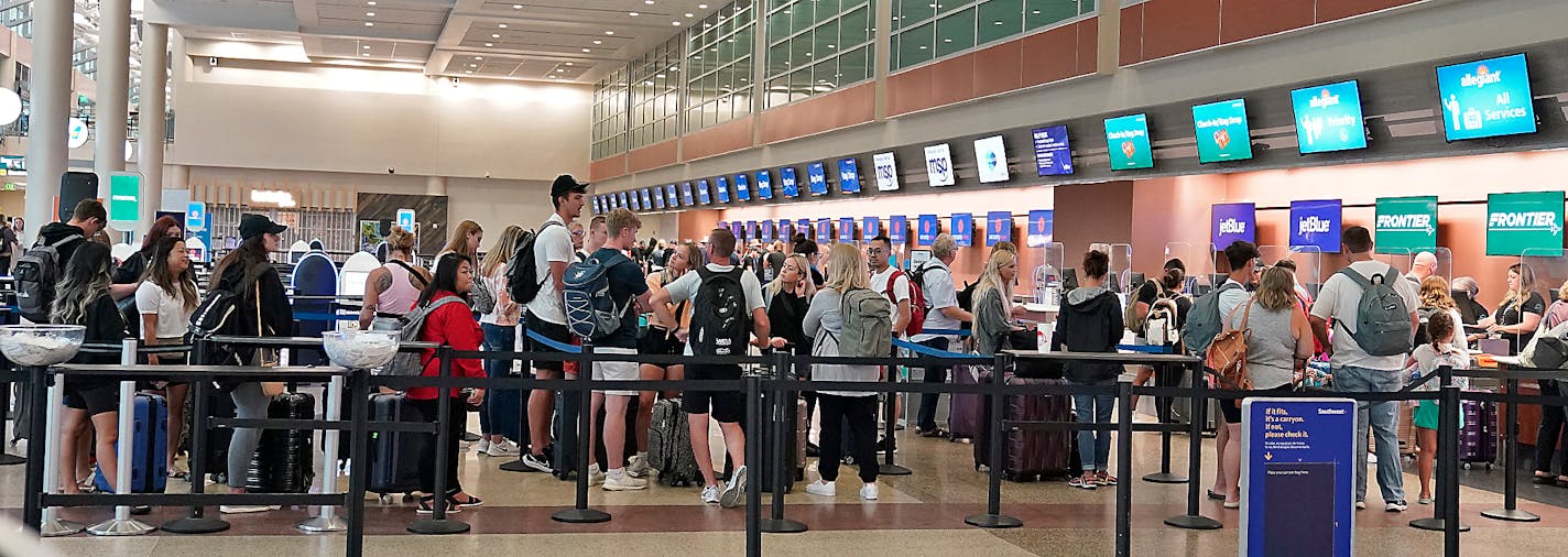 Travelers at Minneapolis-St. Paul International Airport in summer 2022.