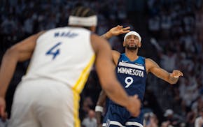 The Timberwolves' Nickeil Alexander-Walker signals satisfaction after he hit a three-pointer in the third quarter of Game 2 on Thursday, when he score