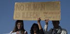 Protester hold a banner as they demonstrate against deportations planned at the port of Mytilini, Lesbos island, Greece, on Monday, April 4, 2016, dur