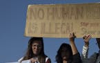 Protester hold a banner as they demonstrate against deportations planned at the port of Mytilini, Lesbos island, Greece, on Monday, April 4, 2016, dur