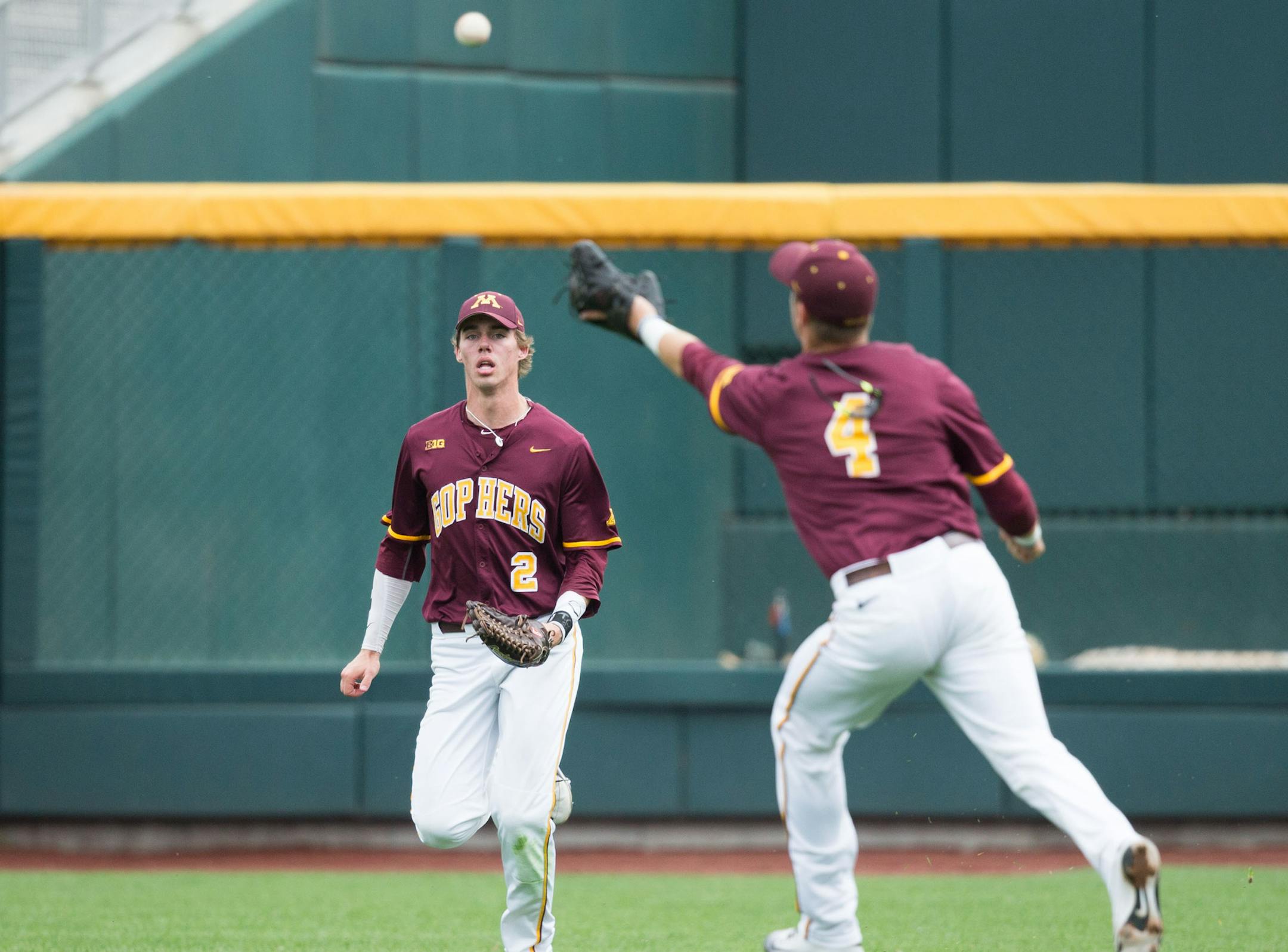 Omaha, Nebraska -- Minnesota's Conor Schaefbauer, No. 4, misses a fly ball by Iowa's Mason McCoy letting in a run in the third inning of their Big Ten Conference Baseball Tournament game at TD Ameritrade Park on Wednesday, May 25, 2016, in Omaha. Also pictured is Alex Boxwell. (MATT DIXON/THE WORLD-HERALD)