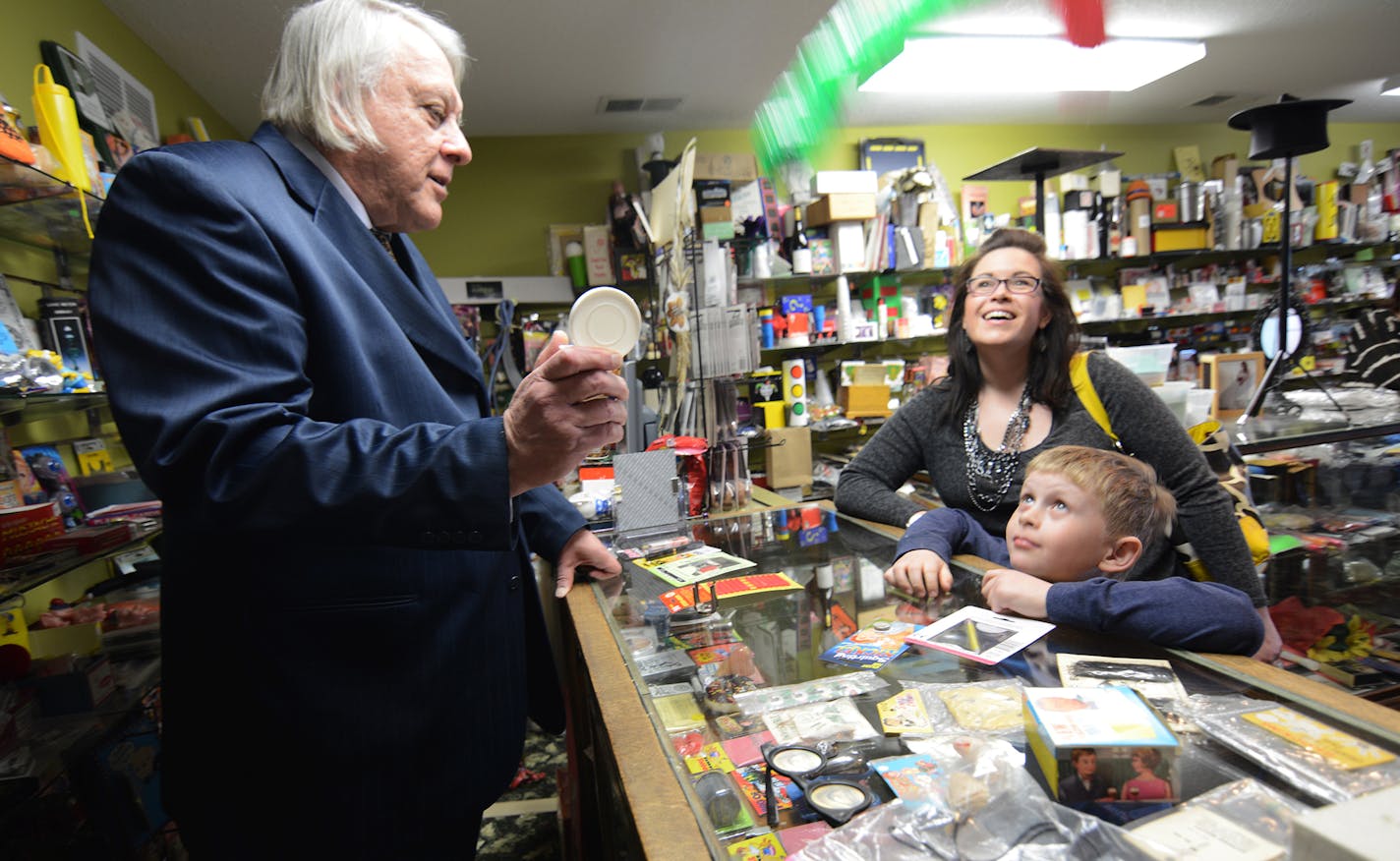 Larry Kahlow, of Eagle Magic, demonstrated the snake-in-a-can gag for Miriam and Sleven Olson, 8, of Burnsville. Photo by Liz Rolfsmeier, Special to the Star Tribune