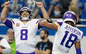 Minnesota Vikings quarterback Kirk Cousins (8) left and receiver Justin Jefferson (18) celebrated Minnesota Vikings Adam Thielen (19) third quarter to