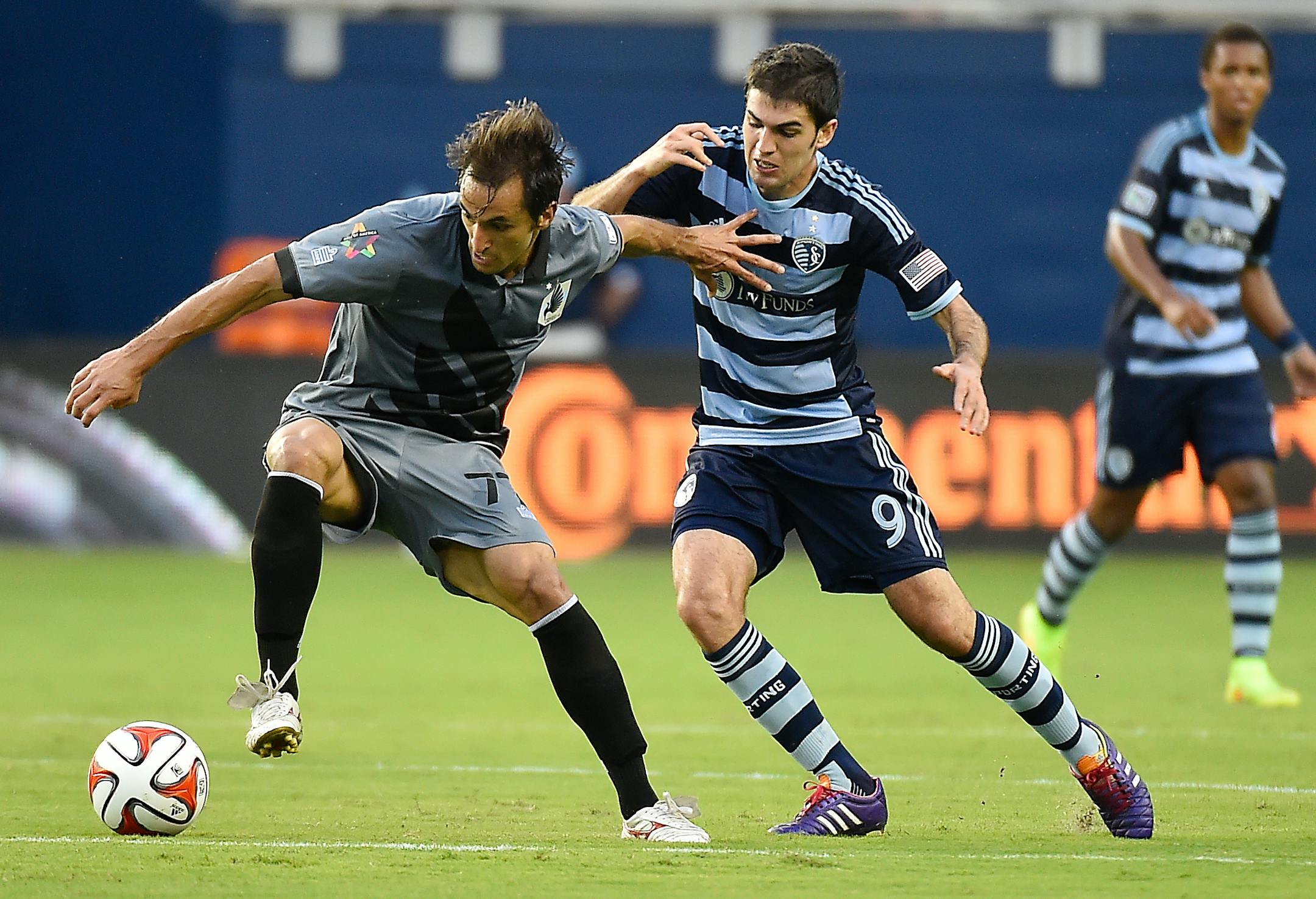 Minnesota midfielder Juliano Vicentini (77) keeps Sporting forward Antonio Dovale away from the ball during a match in 2014.