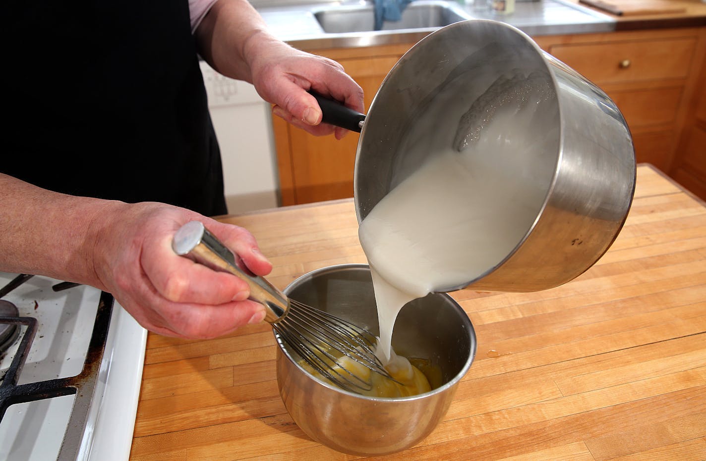 Coconut cake.] JIM GEHRZ &#x201a;&#xc4;&#xa2; jgehrz@startribune.com / Minneapolis, MN / April 4, 2014 / 1:00 PM BACKGROUND INFORMATION: Reporter Kim Ode bakes a coconut cake for Baking Central, complete with step-by-step photos showing the making of batter and custard, assembling and decorating.