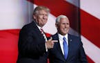 Republican Presidential Candidate Donald Trump, greets Republican Vice Presidential Nominee Gov. Mike Pence of Indiana during the third day session of