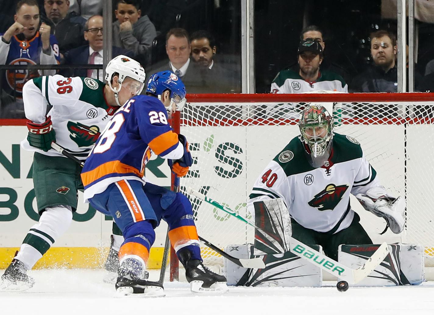 Wild goaltender Devan Dubnyk blocked a shot as Islanders left winger Michael Dal Colle (28) threatened with Wild defenseman Nick Seeler trying to bottle him up near the net in the third period Sunday.