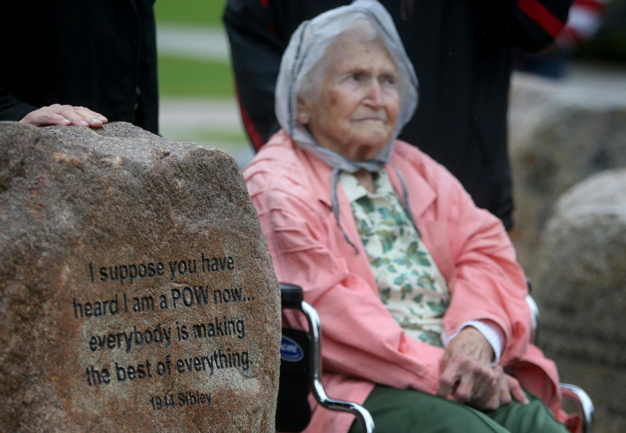 Mollie Kuhlman, 93, sits next to a stone with part of a message written to her as a young woman by her husband WWII Air Force pilot Roy Kuhlman, who was also a POW during the war.