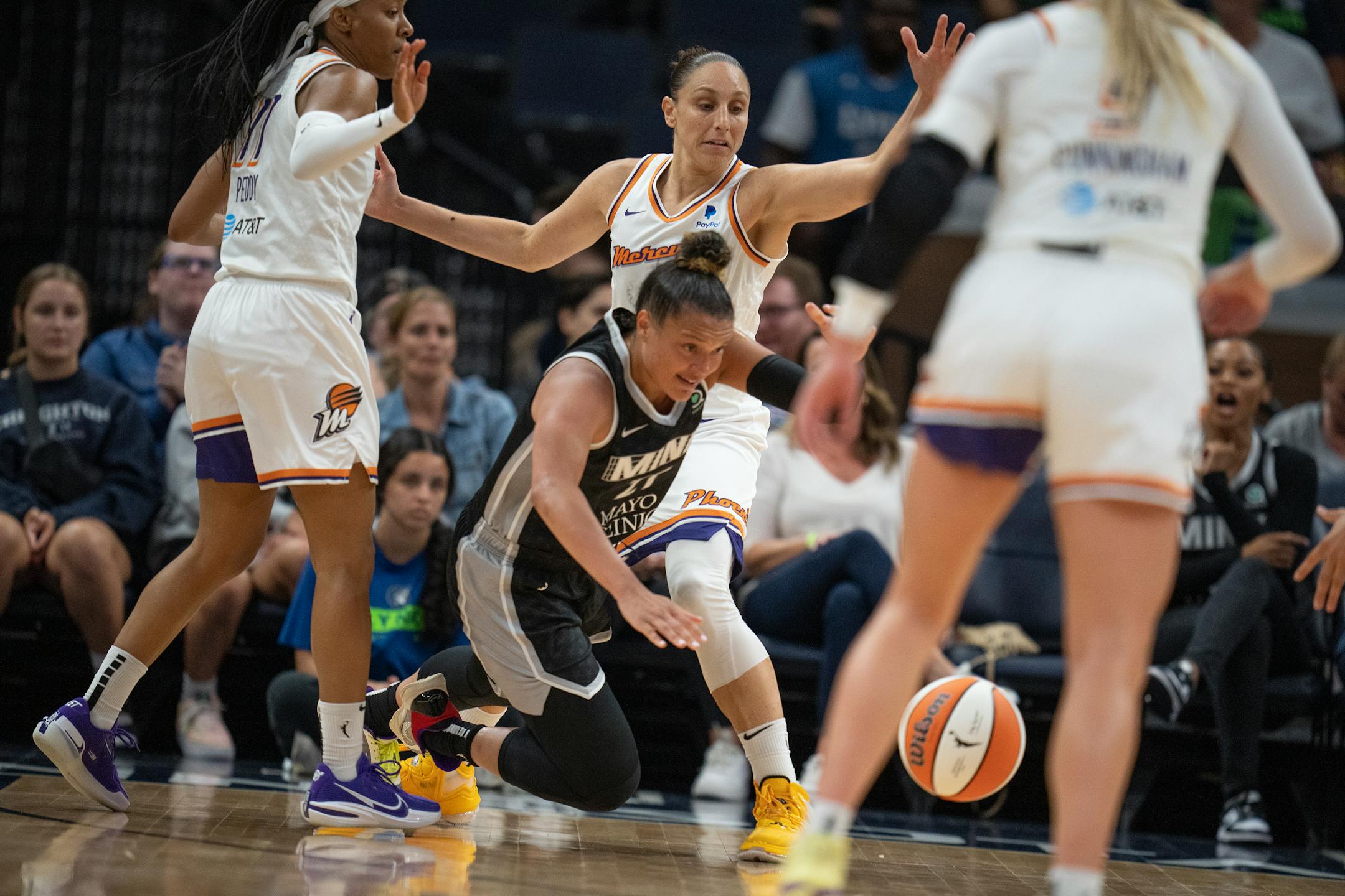 Minnesota Lynx guard Kayla McBride (21) lost control of the ball in front of Phoenix Mercury guard Diana Taurasi (3) in the second half.