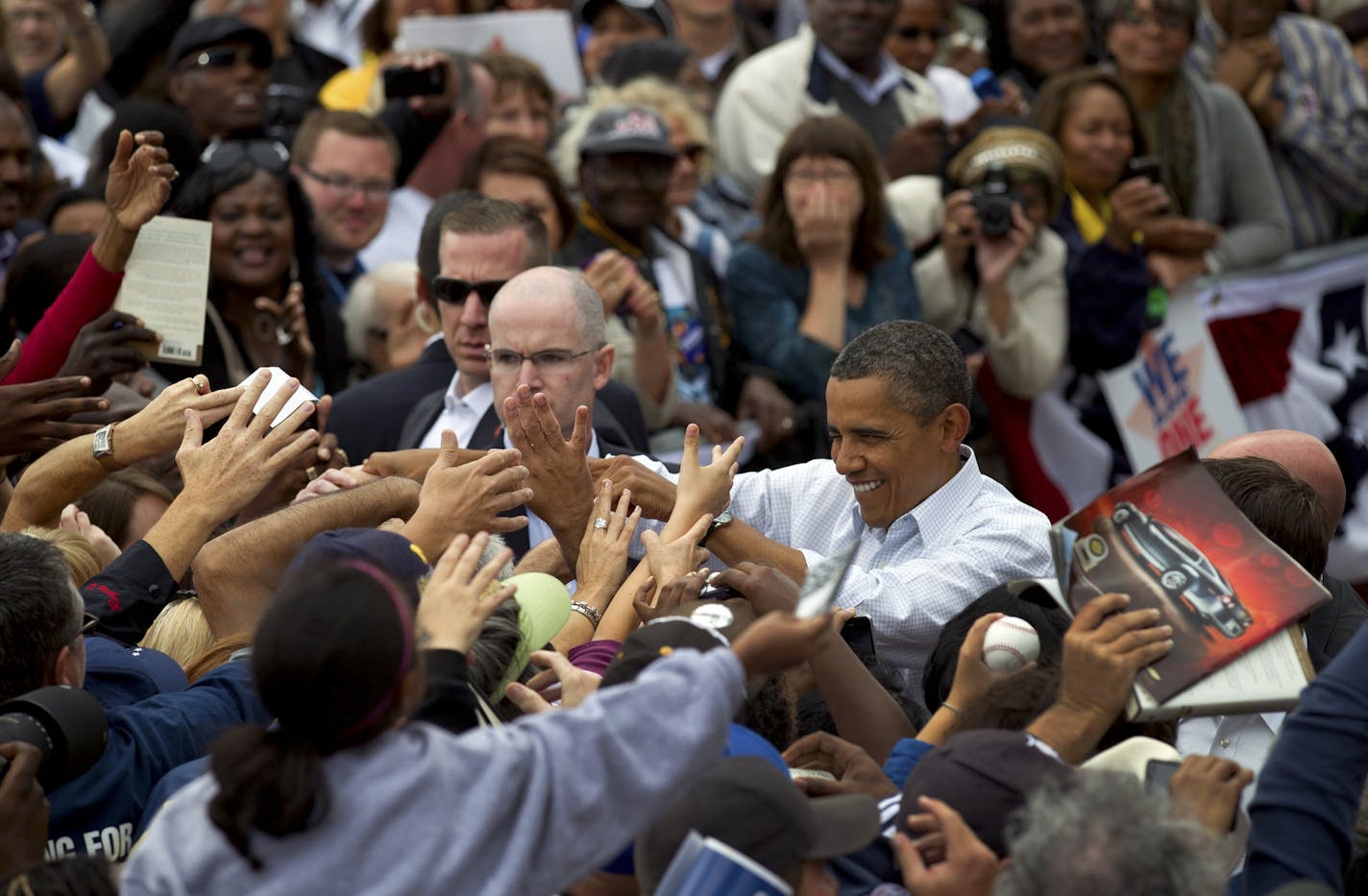 President Barack Obama greets the crowd after delivering remarks at a labor rally in front of the General Motors headquarters in Detroit on Monday.