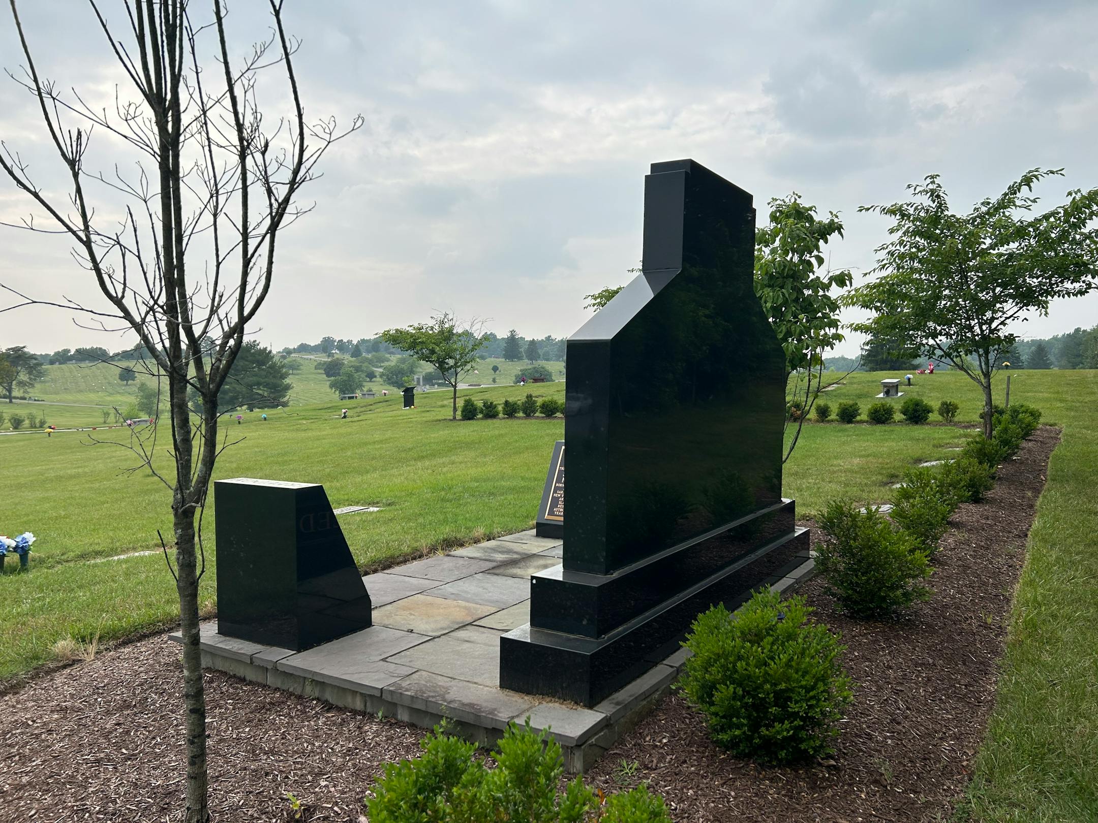 Seven miles southwest of the Northup-Reed monument in National Harmony Memorial Park in Landover, Md., the U.S. Capitol dome carries the Statue of Freedom, obscured here by clouds and smoke from wildfires in Canada. MUST CREDIT: Washington Post photo by Gillian Brockell