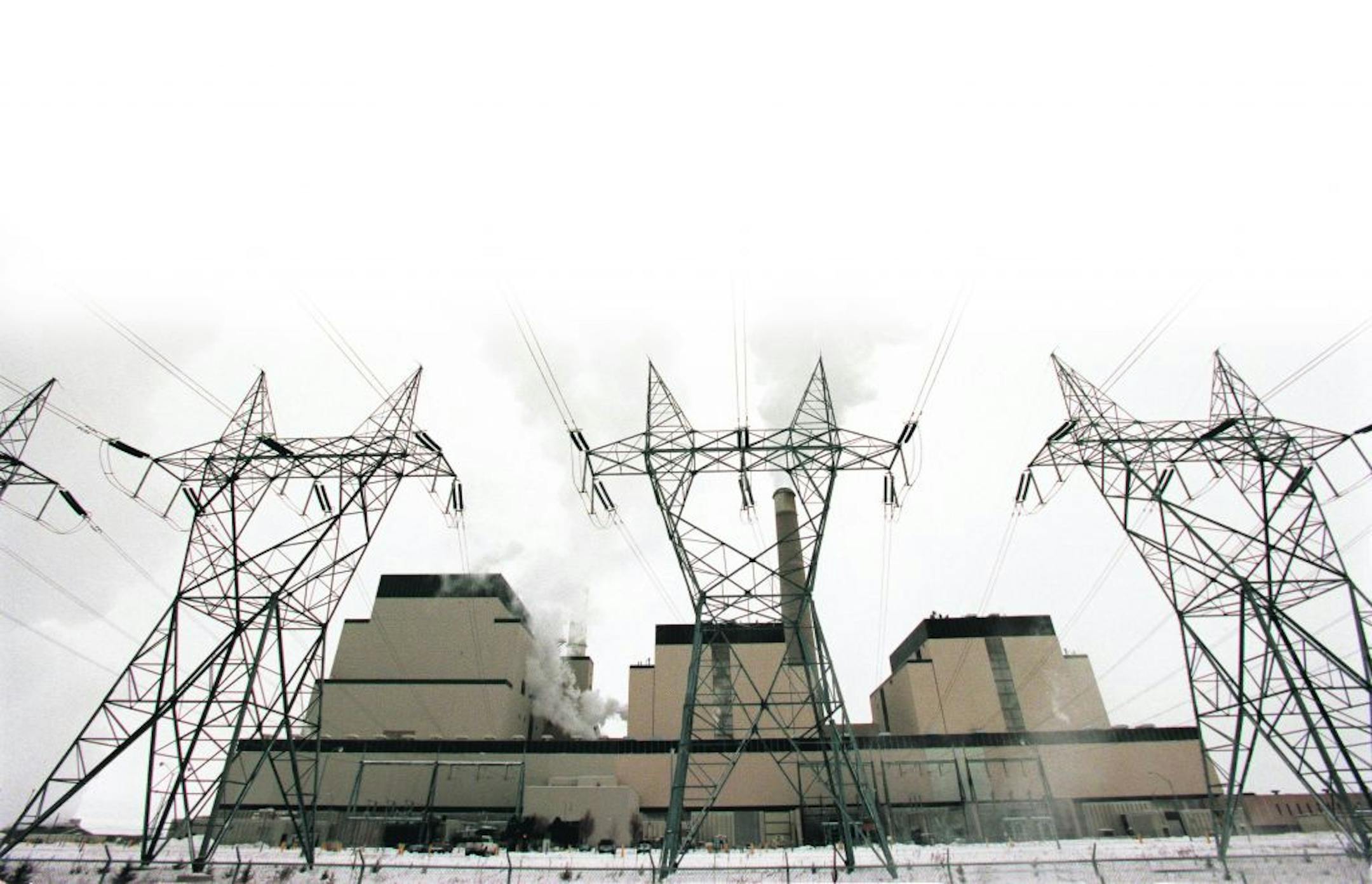 Becker, Mn., Sat., Dec. 30, 2000--(The buildings, left to right) Units 3, 2 and 1 of the Sherco Generating Plant in Becker, Mn., The transmission towers in front of the units are part of the Sherco Substation. Transmission lines carry electricity from the power plant to the substation. There the voltage is lowered before feeding it to a distribution system. Transformers provide correct voltage for customers.