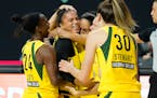 Seattle Storm forward Alysha Clark celebrates her game-winning shot with guard Jewell Loyd (24) and forward Breanna Stewart (30) during the second hal