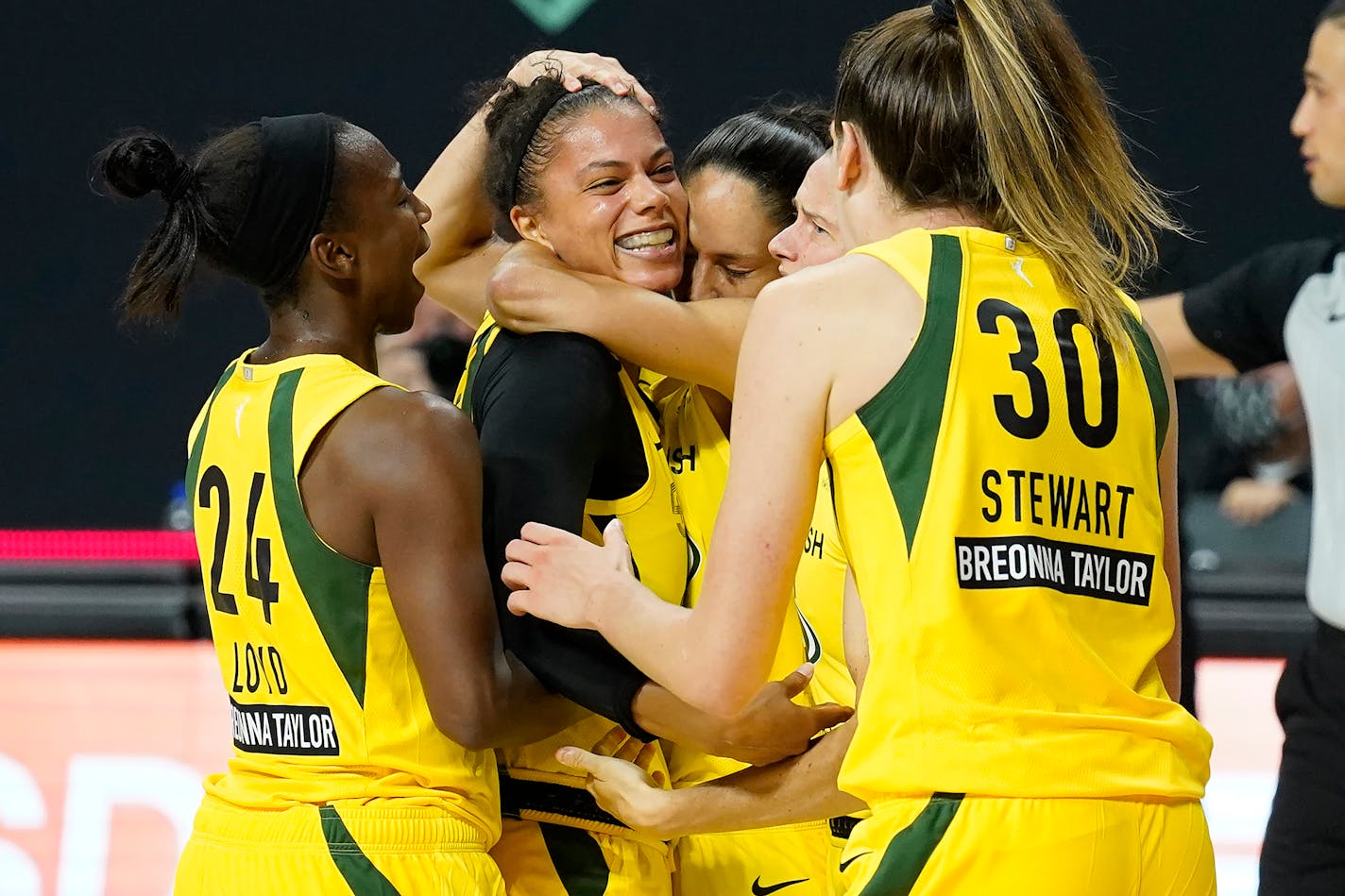 Seattle Storm forward Alysha Clark celebrates her game-winning shot with guard Jewell Loyd (24) and forward Breanna Stewart (30) during the second half of Game 1 of a WNBA basketball semifinal round playoff series against the Minnesota Lynx Tuesday, Sept. 22, 2020, in Bradenton, Fla. (AP Photo/Chris O'Meara)