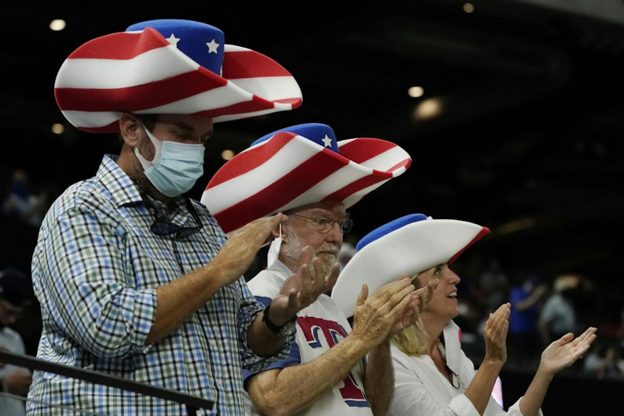 Fans watch during the third inning in Game 1 of the baseball World Series between the Los Angeles Dodgers and the Tampa Bay Rays Tuesday, Oct. 20, 2020, in Arlington, Texas.