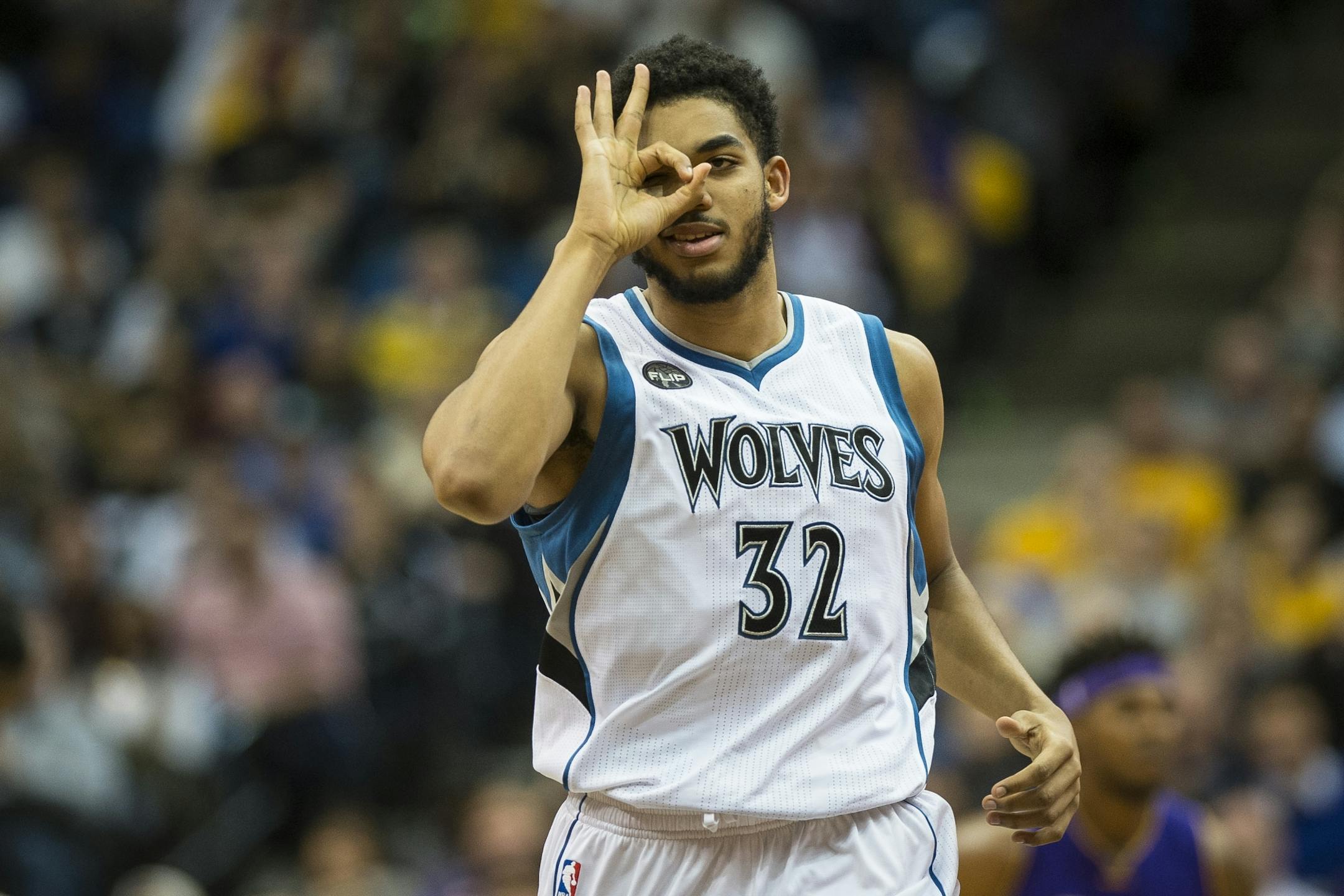 Minnesota Timberwolves center Karl-Anthony Towns (32) gestured to guard Kevin Martin (23) after Martin hit a 3-point shot in the fourth quarter against the Los Angeles Lakers.