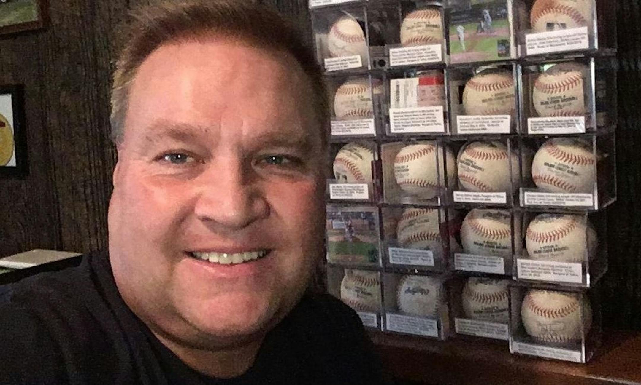 Jason Gabbert, with a partial collection of baseballs he has amassed attending Major League Baseball games. (Courtesy Jason Gabbert)