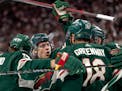 The Wild’s Joel Eriksson Ek (14) celebrated with linemates Marcus Foligno, left, and Jordan Greenway (18) after scoring in the first period in Game 