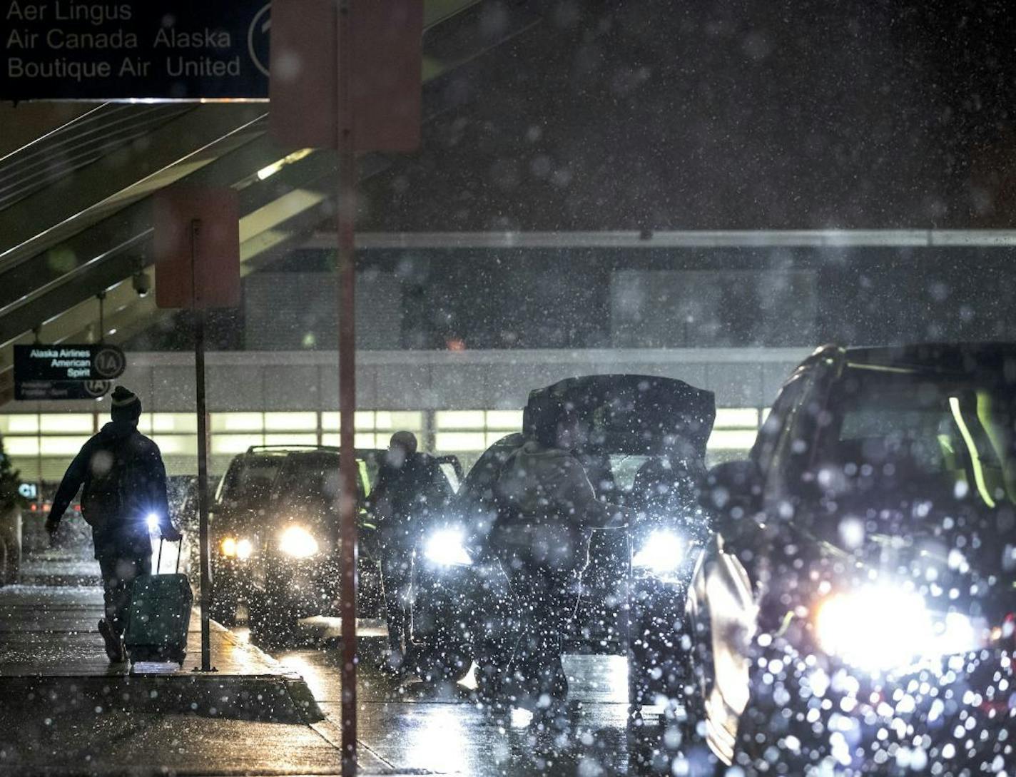 The snow began flying late Tuesday at Minneapolis-St. Paul International Airport, just in time for busy holiday travel.