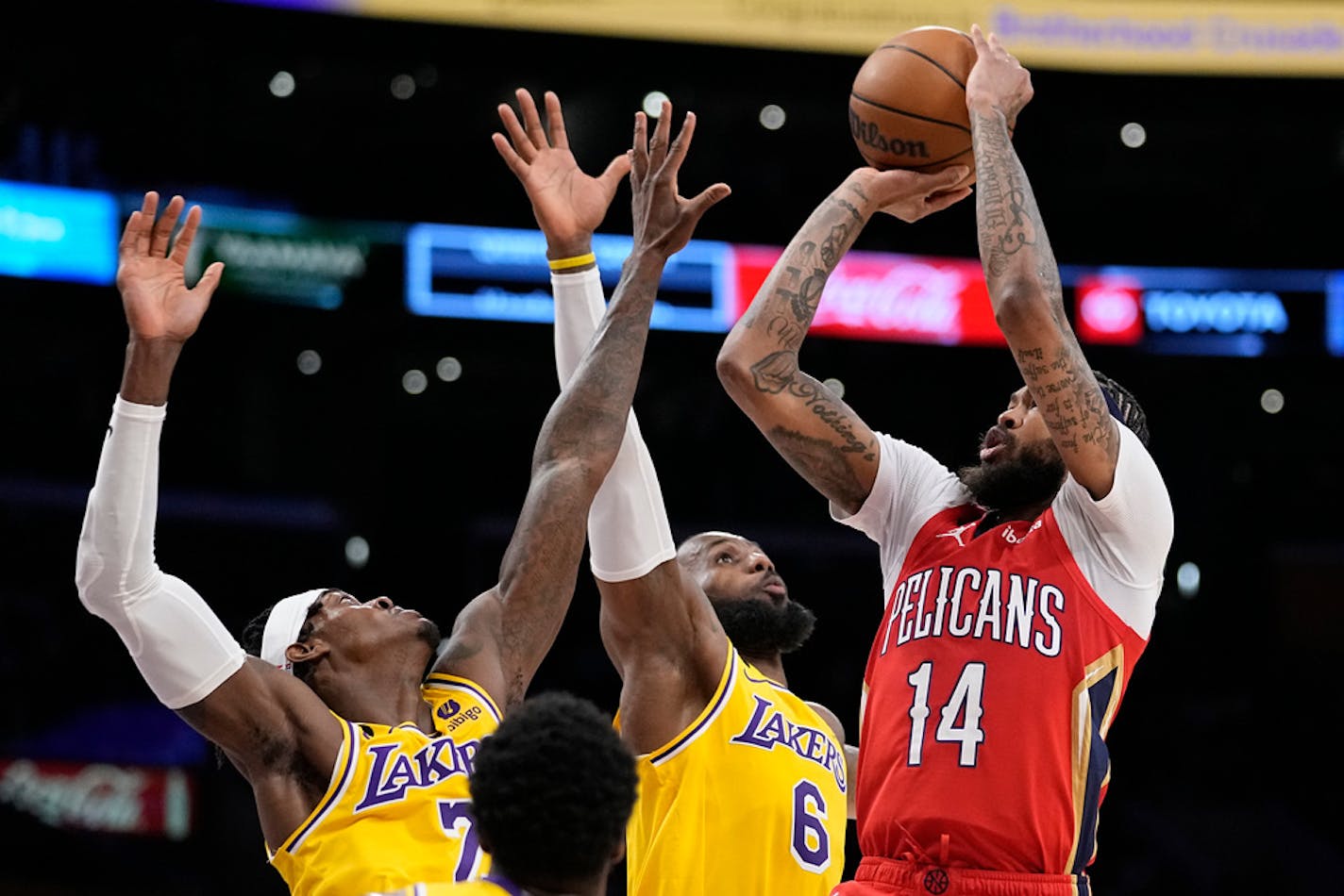 New Orleans Pelicans forward Brandon Ingram, right, shoots as Los Angeles Lakers forward Jarred Vanderbilt, left, and forward LeBron James defend during the first half of an NBA basketball game Wednesday, Feb. 15, 2023, in Los Angeles. (AP Photo/Mark J. Terrill)