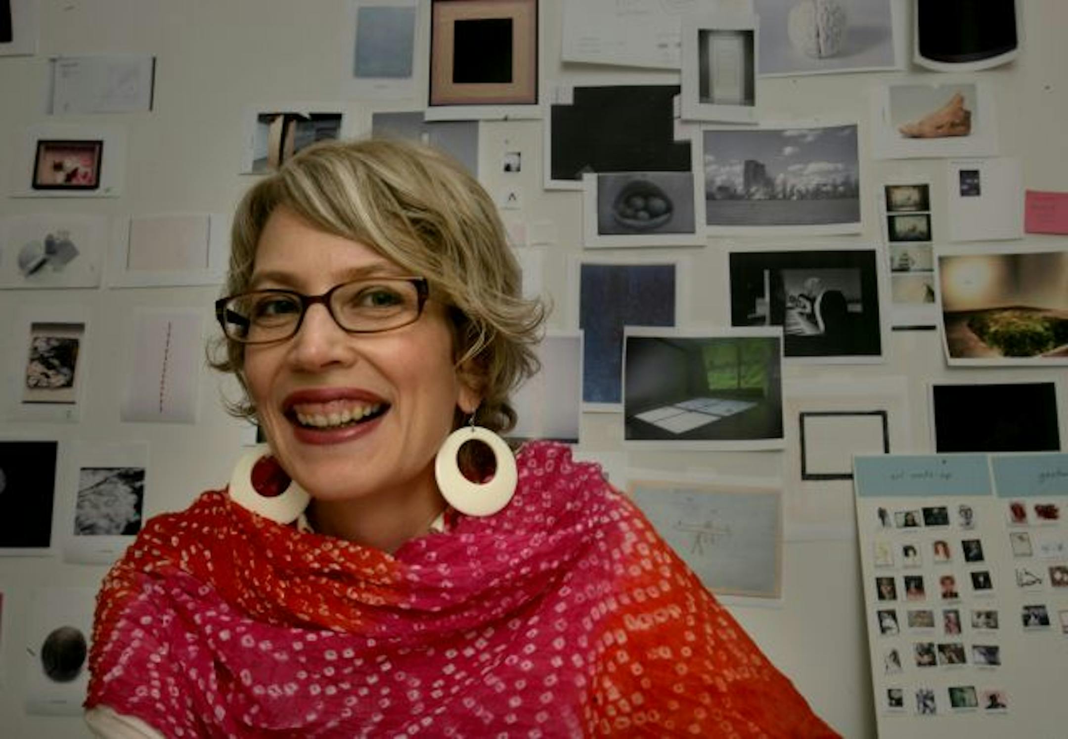 Darsie Alexander, Walker's new chief curator (started Nov. 2008) in her office, with a wall of Xeroxes of art behind her.