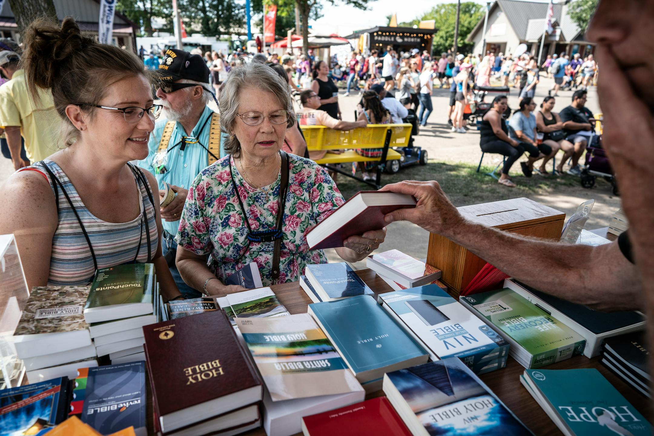 Carlee Reierson, left, and her mother, Carol Marz, were given a free Bible at the Crossroads Chapel on the Minnesota State Fairgrounds.