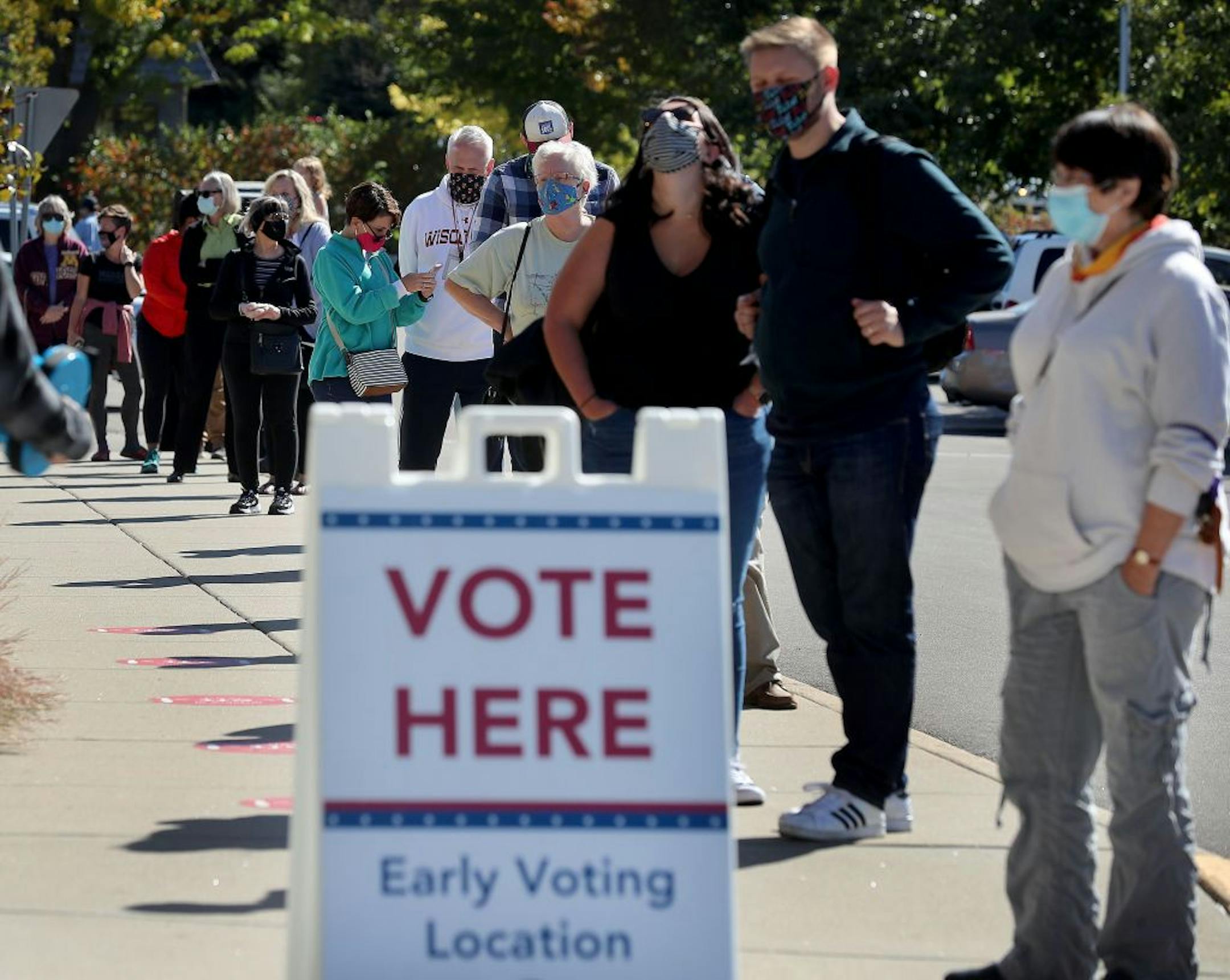 A long line of voters waited to cast their ballots during early voting at Ramsey County Library Friday in Roseville.