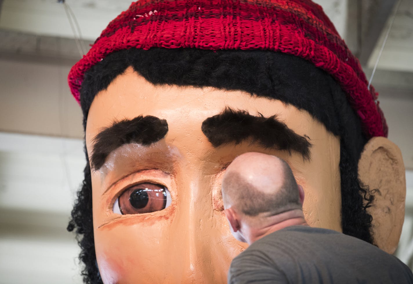 Jeff Stuhr of the Minnesota Pollution Control Agency gets a closer look at Paul Bunyan's eyes, which were ordered from Amazon. ] (Leila Navidi/Star Tribune) leila.navidi@startribune.com BACKGROUND INFORMATION: Inside the Eco Experience Building at the Minnesota State Fairgrounds in Falcon Heights on Thursday, August 18, 2016. The Minnesota Pollution Control Agency will unveil at the State Fair a 20 foot tall Paul Bunyan dressed in completely recycled fabrics. Exhibit will remind Minnesotans that