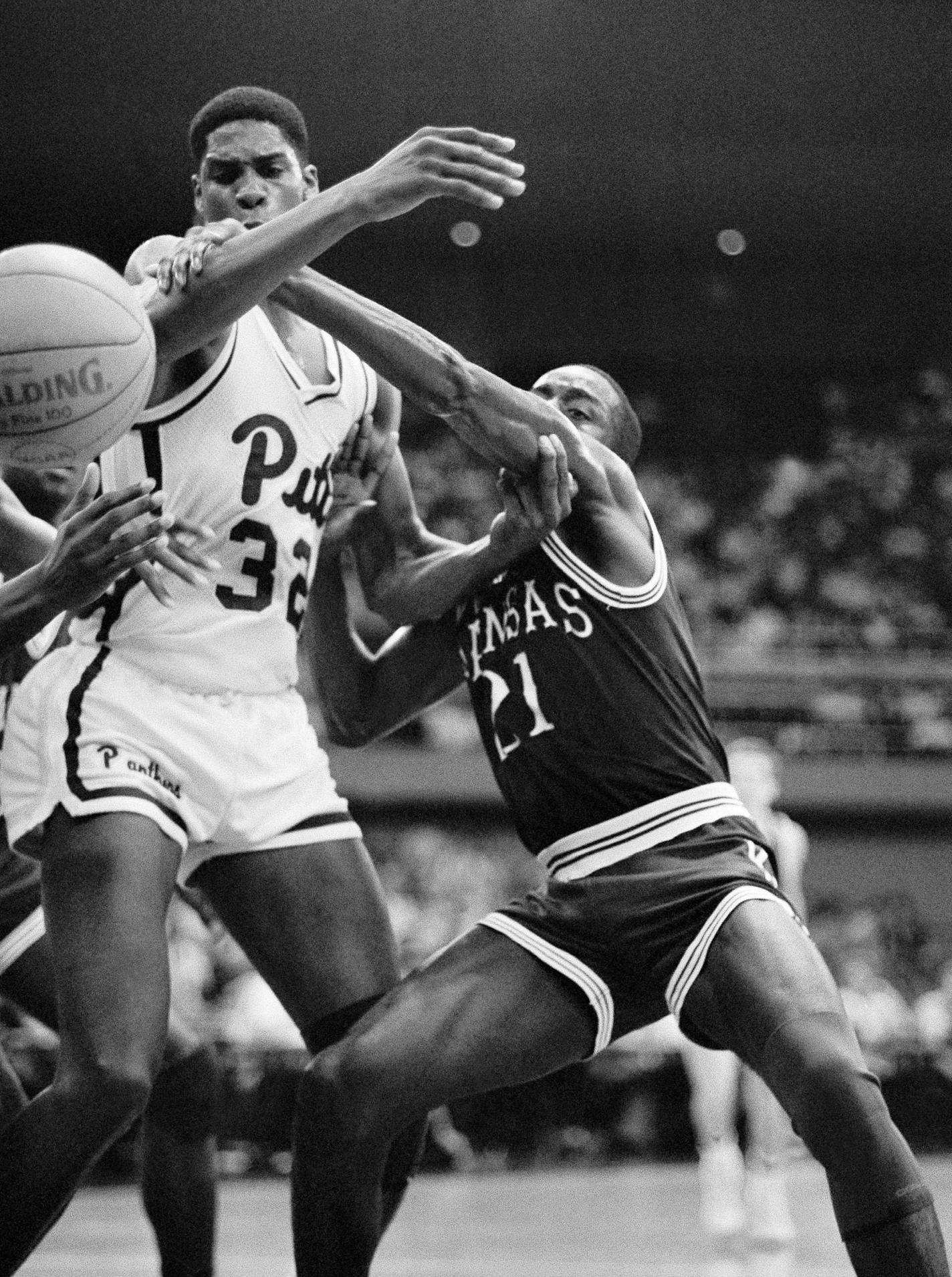 Pitt center Charles Smith, left, and Kansas forward Milt Newton battle for possession of the ball during the first half of their game at the Rainbow Classic on December 29, 1986 in Honolulu.(AP Photo/Eric Risberg) ORG XMIT: APHS60001