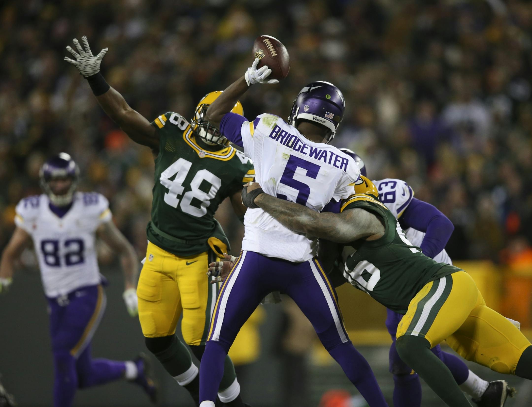 Vikings quarterback Teddy Bridgewater (5) was pressured by Packers linebacker Joe Thomas (48) and Packers outside linebacker Mike Neal (96) in the third quarter Sunday night.