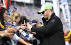 Dale Earnhardt Jr. signs autographs before the NASCAR Sprint Cup Series auto race at Texas Motor Speedway in Fort Worth, Texas, Sunday, Nov. 2, 2014. 