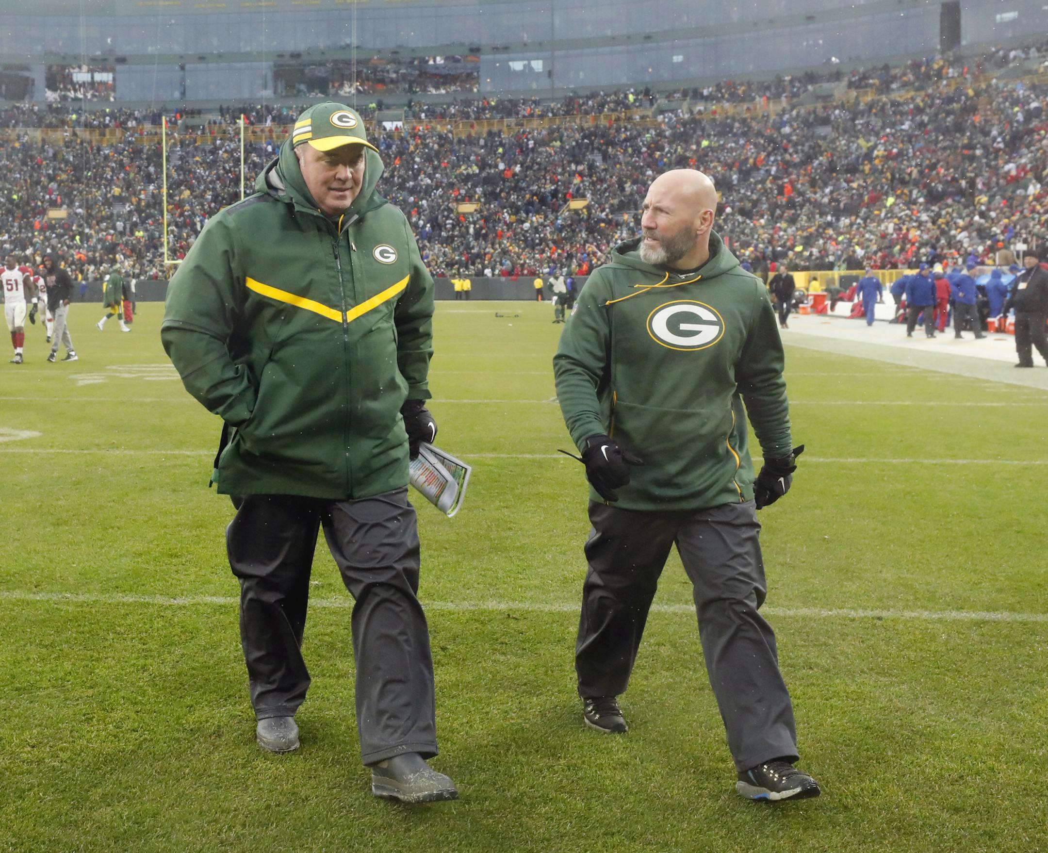 Green Bay Packers head coach Mike McCarthy, left, leaves the field after an NFL football game against the Arizona Cardinals, Sunday, Dec. 2, 2018, in Green Bay, Wis. McCarthy was fired after the game. (AP Photo/Jeffrey Phelps)