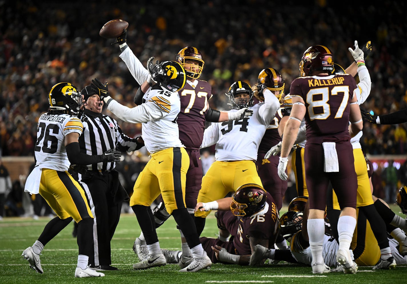 Iowa Hawkeyes players, including defensive lineman Deontae Craig (45), celebrate a Minnesota fumble by running back Mohamed Ibrahim (24) during the fourth quarter of an NCAA football game Saturday, Nov. 19, 2022 at Huntington Bank Stadium in Minneapolis, Minn.. ] AARON LAVINSKY • aaron.lavinsky@startribune.com