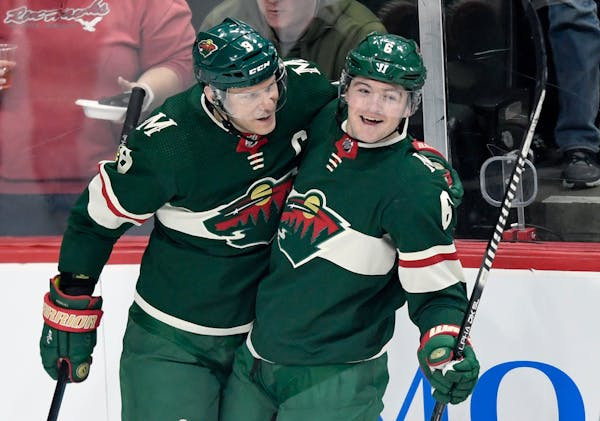 Minnesota Wild's Mikko Koivu (9), of Finland, and Ryan Donato (6) celebrate a goal by Donato against the Washington Capitals during the first period o