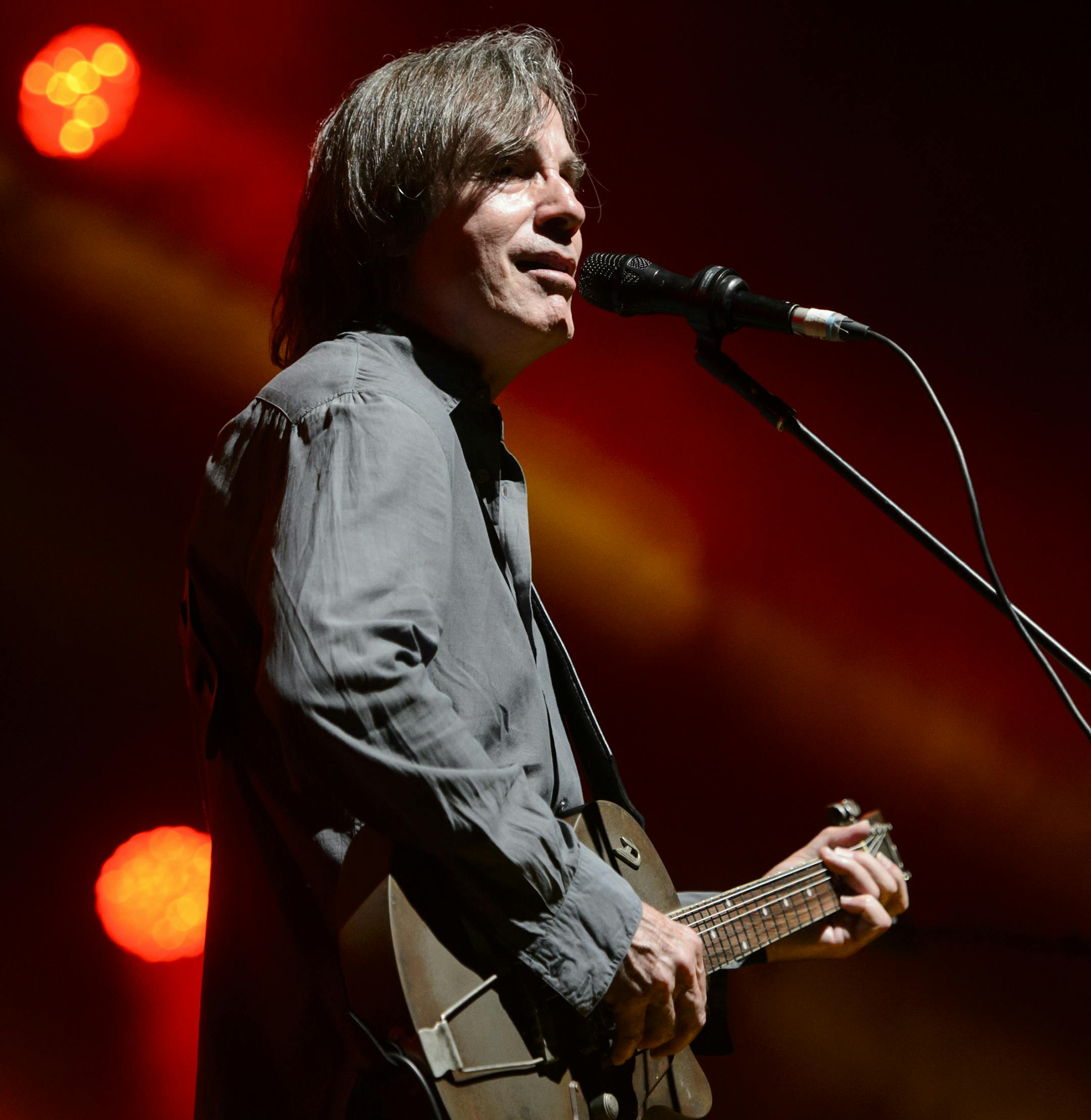 In this Saturday July 4, 2015 picture US singer Jackson Browne performs on the Stravinski Hall stage at the 49th Montreux Jazz Festival, in Montreux, Switzerland, (Jean-Christophe Bott/Keystone via AP)