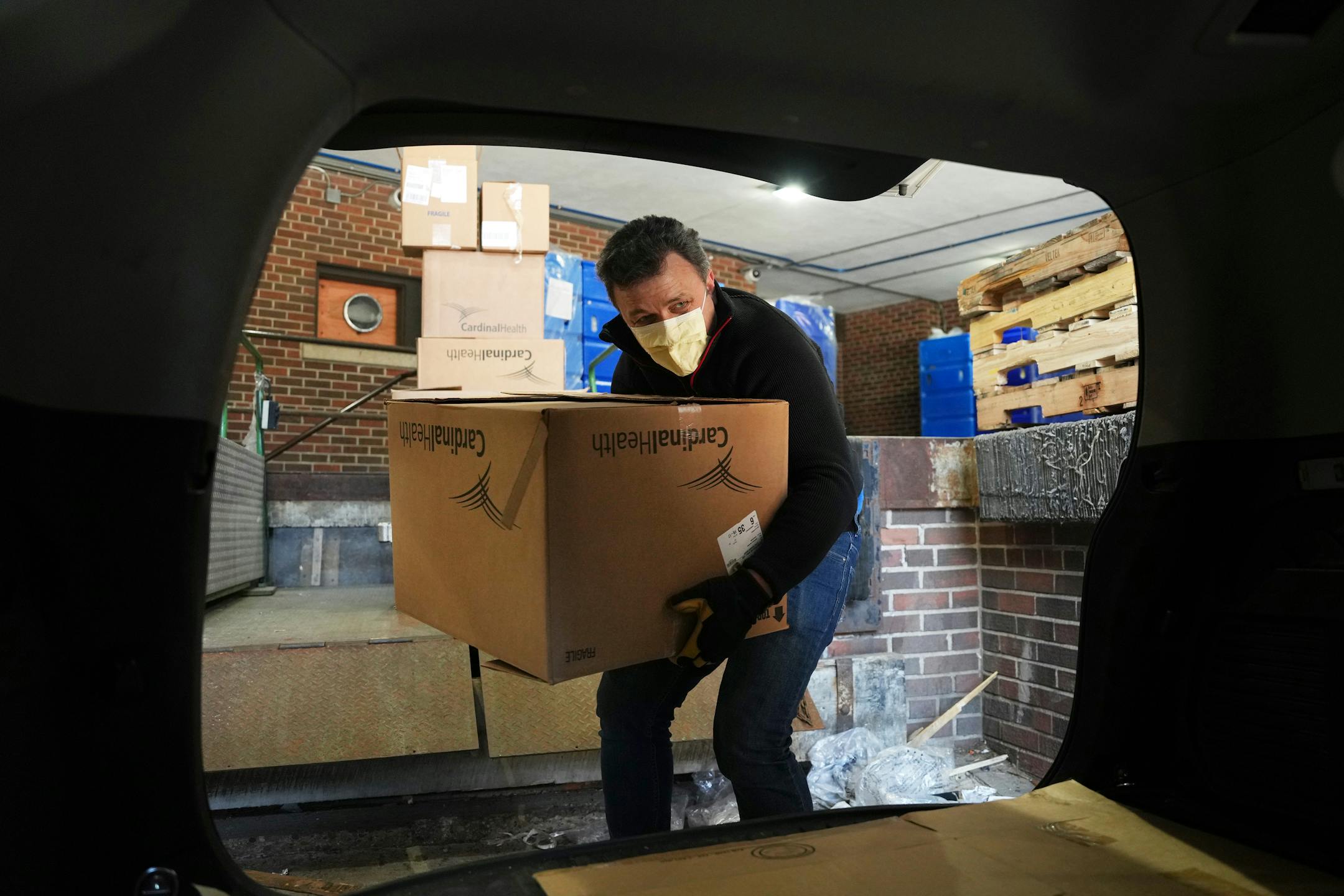 Mykola Sarazhynskyy, a volunteer with Stand with Ukraine MN, loads boxes of surplus medical supplies.