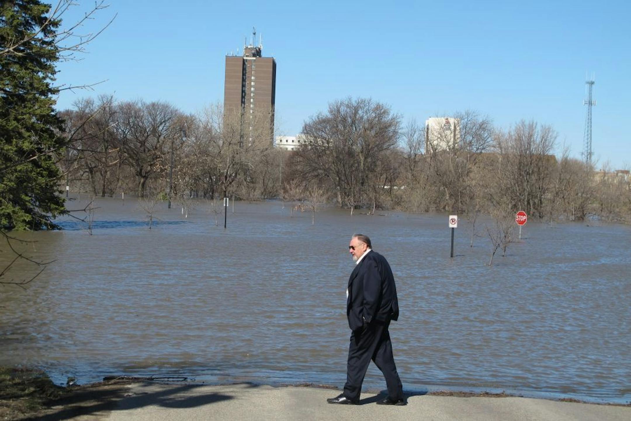 Fargo, N.D. Mayor Dennis Walaker looks at flooding from the Moorhead, Minn., side of the Red River on Tuesday, April 30, 2013. The river is expected to crest Wednesday at about 18 feet above flood stage.
