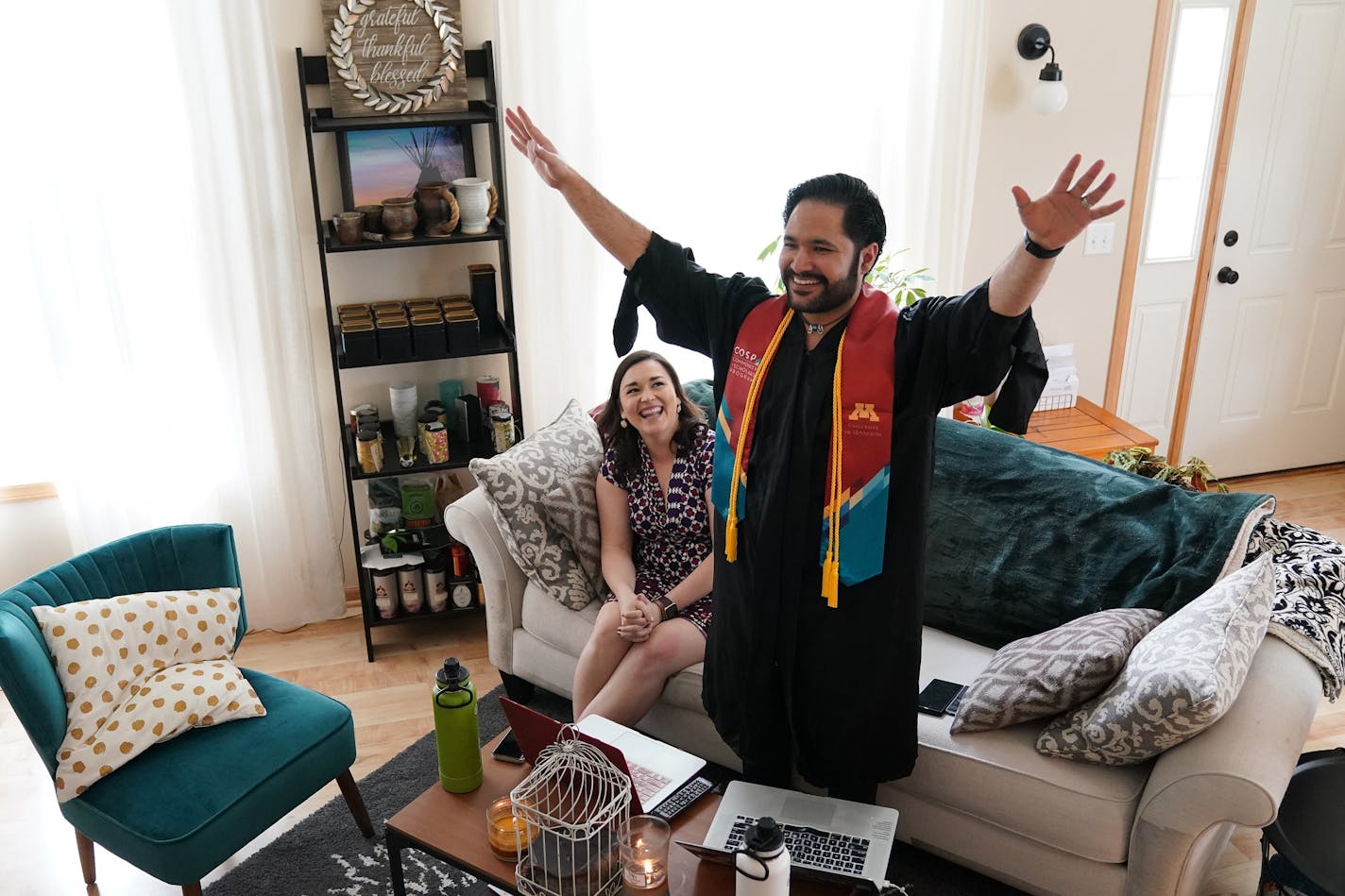 Izaak Mendoza celebrated as he watched to the video commencement address in his graduation robes alongside his wife Becky and his family who were on a video call from their home in Wyoming Saturday.