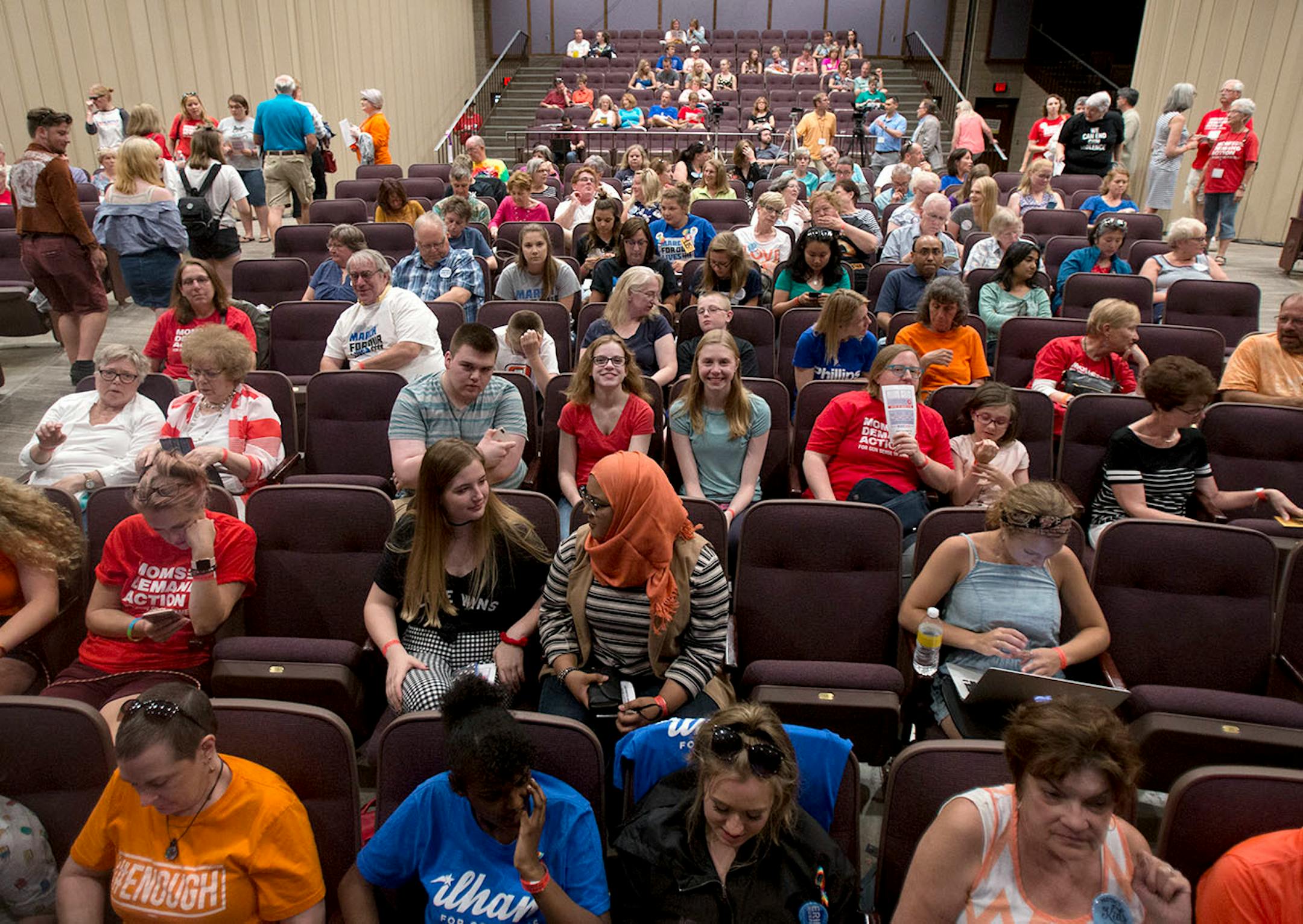 The audience waits intently for the speakers to begin the presentation.