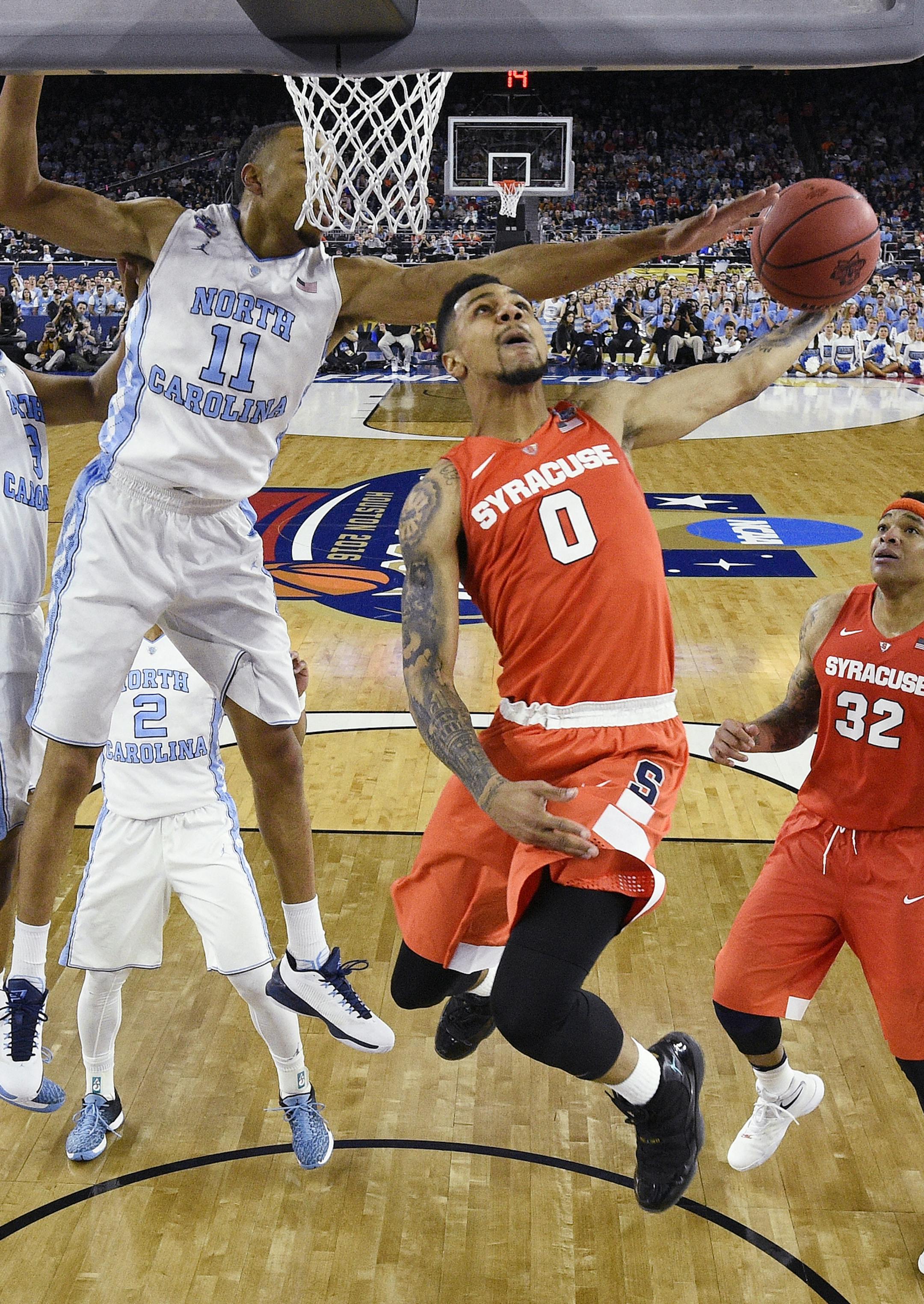 North Carolina forward Brice Johnson (11) defends as Syracuse forward Michael Gbinije (0) tries to shoot during the second half of the NCAA Final Four tournament college basketball semifinal game Saturday, April 2, 2016, in Houston. (Chris Steppig/NCAA Photos via AP, Pool)