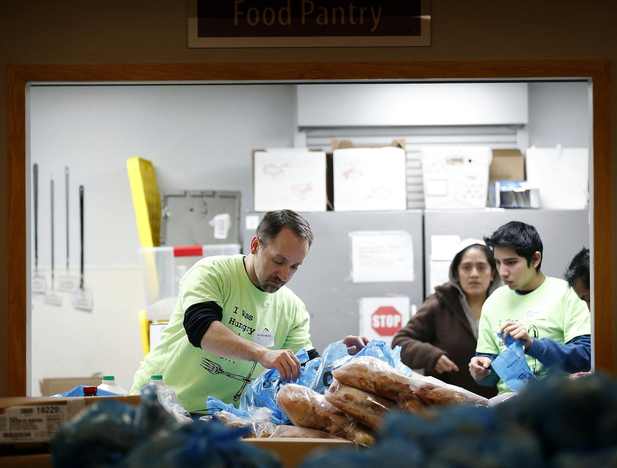 Volunteer Keith Knuth prepared groceries at the Fruit of the Vine food shelf in Burnsville on Tuesday. ] CARLOS GONZALEZ cgonzalez@startribune.com - November 25, 2014, Burnsville, Minn., Fruit of the Vine food shelf