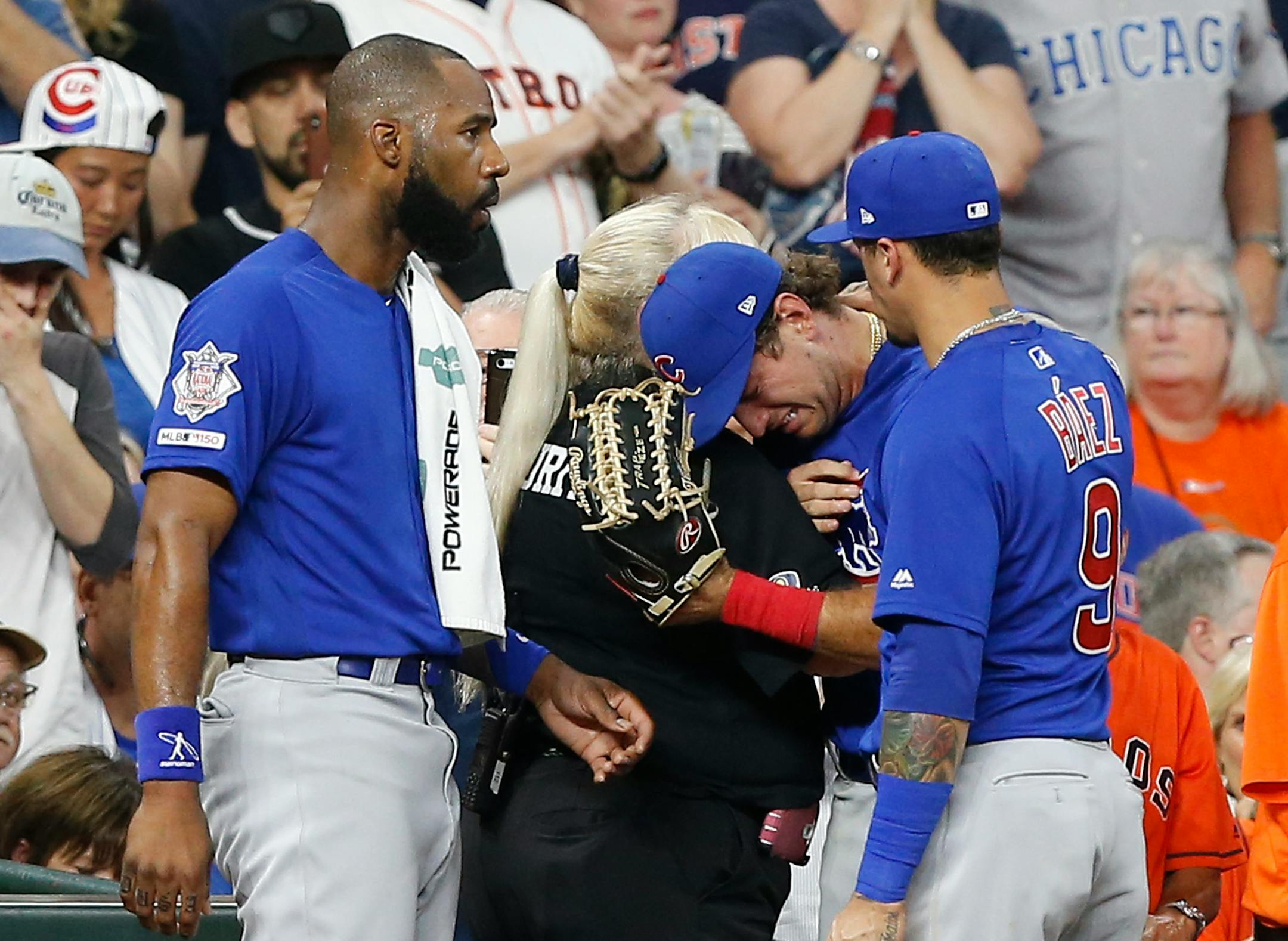 Albert Almora Jr. of the Chicago Cubs was comforted by teammates after checking on a young child who was struck by a hard foul ball off his bat on May 29 during a game in Houston.