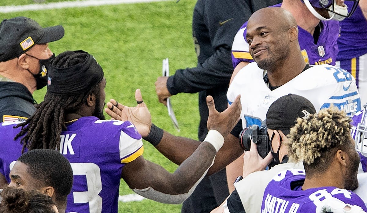 Minnesota Vikings running back Dalvin Cook, left, and former standout Adrian Peterson spoke at the end of a game in 2020.