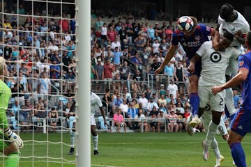 Minnesota United forward Mason Toye (23) blocked FC Cincinnati defender Nick Hagglund (14) as Minnesota United defender Ike Opara (3) headed the ball 